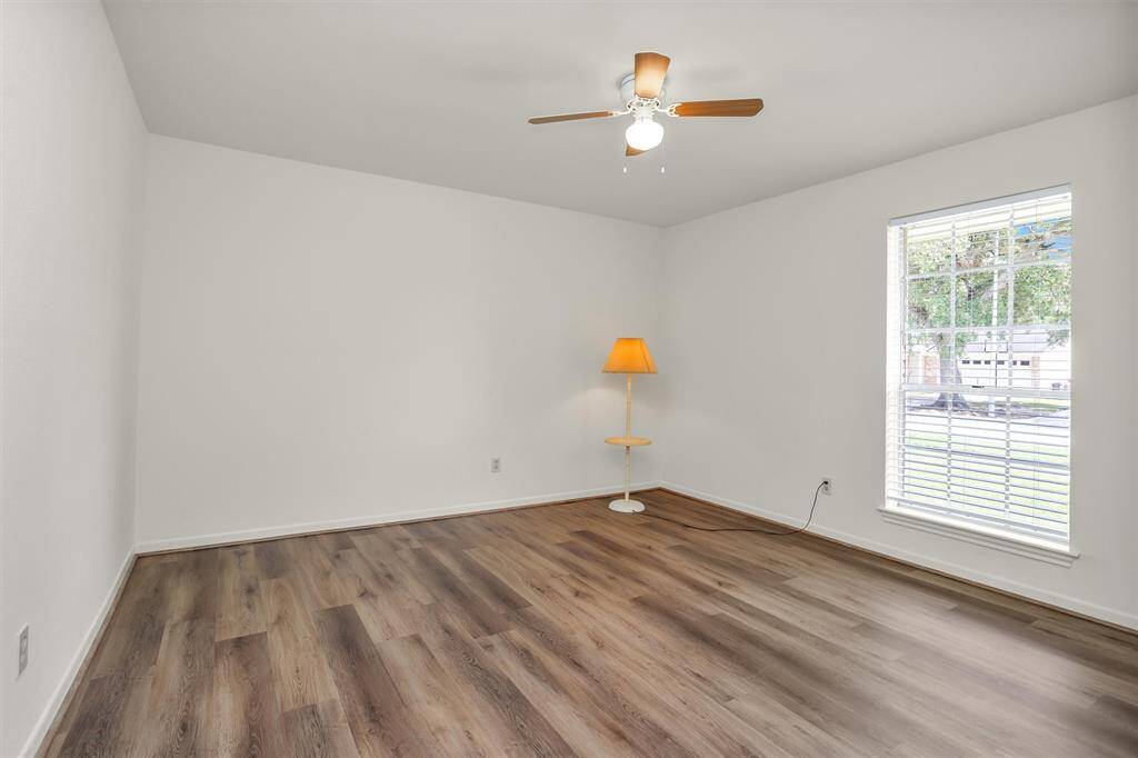 Bedroom #2 features a large window and ceiling fan.