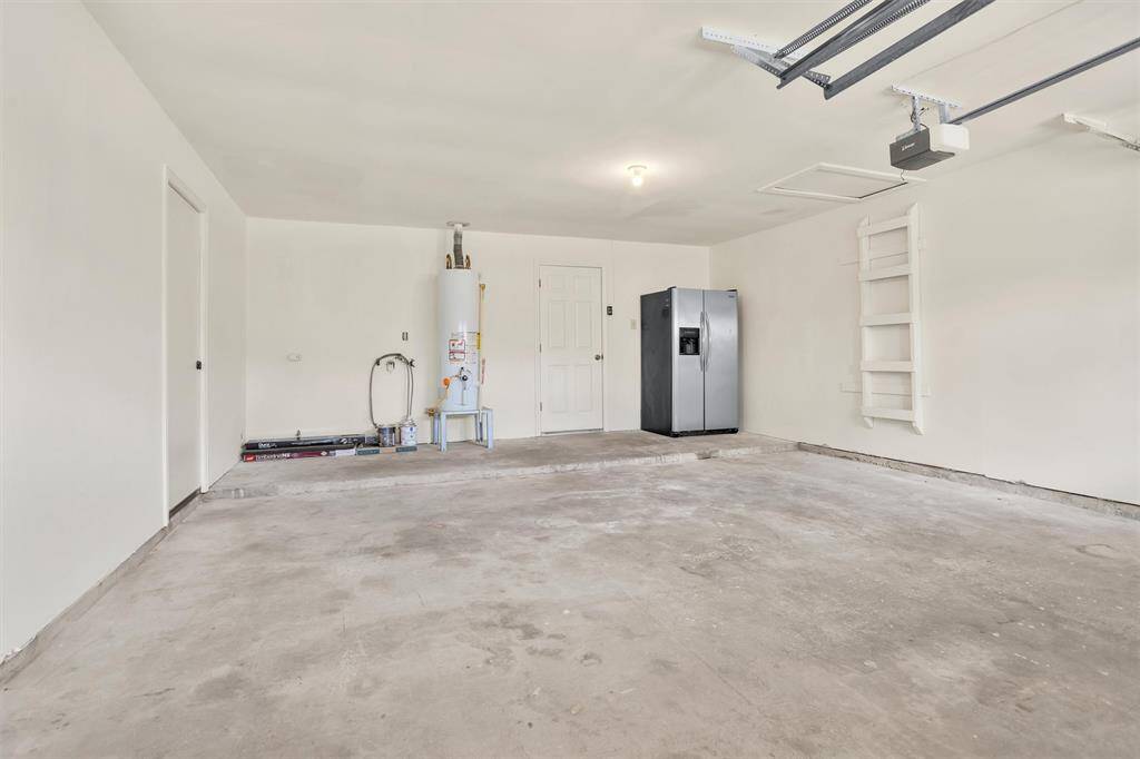 The finished 2-Car Attached Garage houses the new 40-gallon water heater.