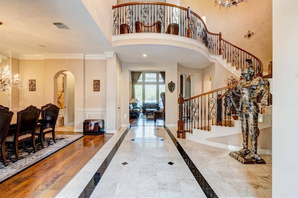 Marble flooring embellishes the marvelous entrance with a splendid mirror sheen. Patterned in a symmetrical manner, the marble beckons attention with a dichotomous color palette.