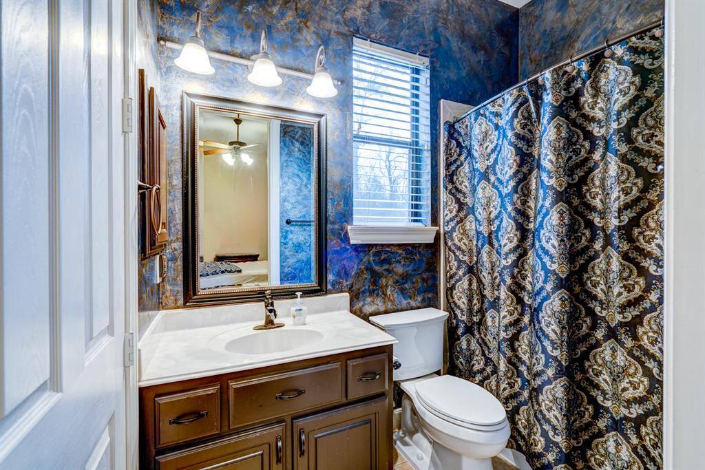 Swirling with ocean blues and earthy bronzes, the second master en suite makes a bold statement of upscale taste.Guests will enjoy the shower/tubcombo and the storage vanity.
