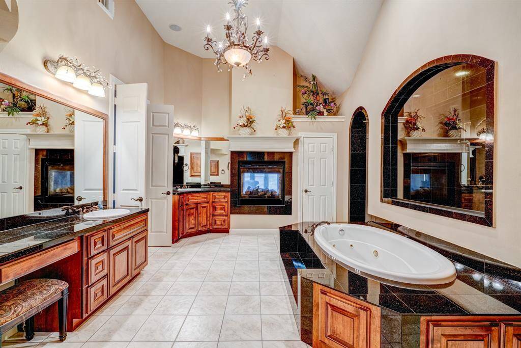 Dual vanities add a touch of practicality to the spa-like en suite. Additionally, one vanity also has a built-in makeup area for a daily dose of feminine charm.