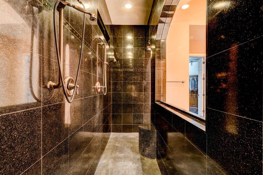Are you ready for this? Boasting a 15’ granite walk-through shower, this overwhelmingly appealing gem has two entrances, two seats, and two sets of shower heads!