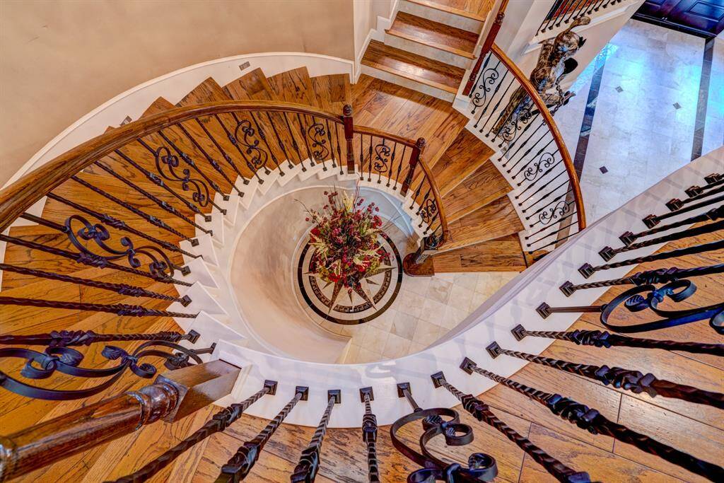 Curving and twisting, the staircase is architecturally a marvel of skill and a testament to time. Each day in this home is gifted with a piece of art and refinement.