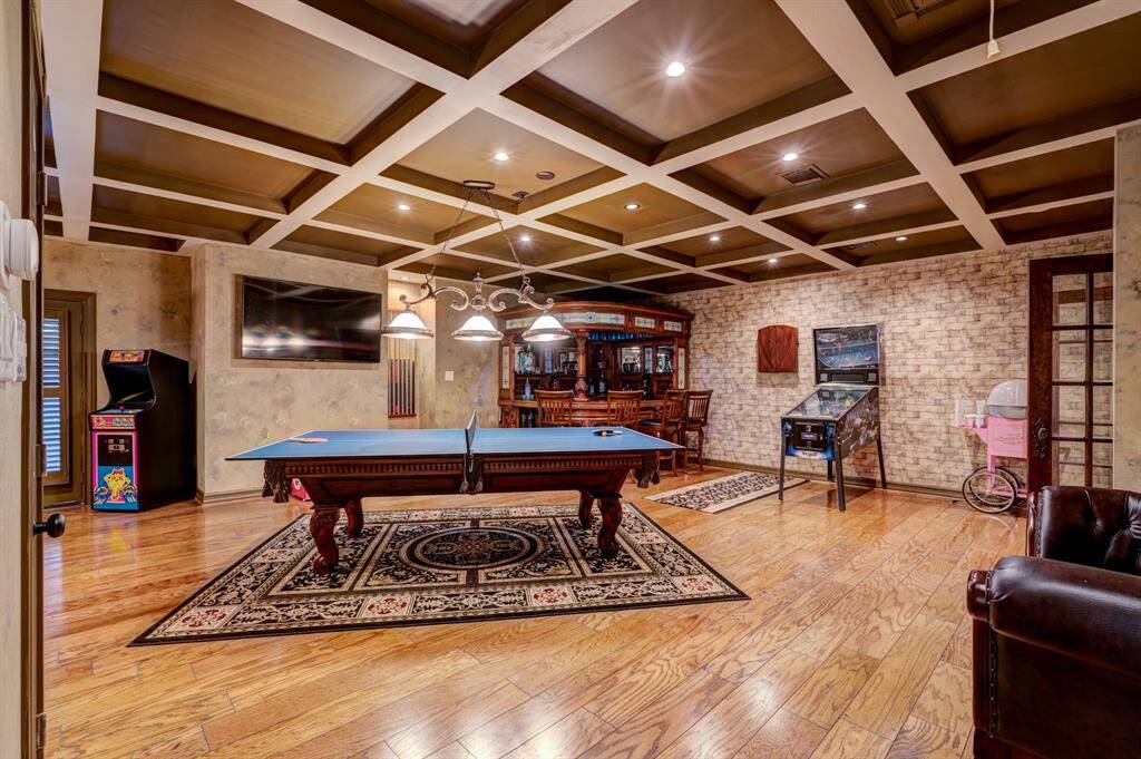 Coffered ceilings and recessed lighting immediately beguile the imagination upon entrance to the game and billiard room.