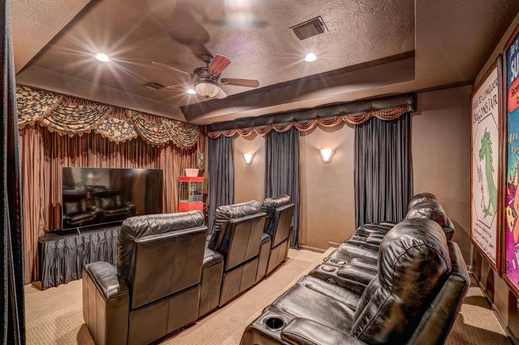 The media room features tray ceilings and an area meant for binge watching favorite sitcoms and classic films.