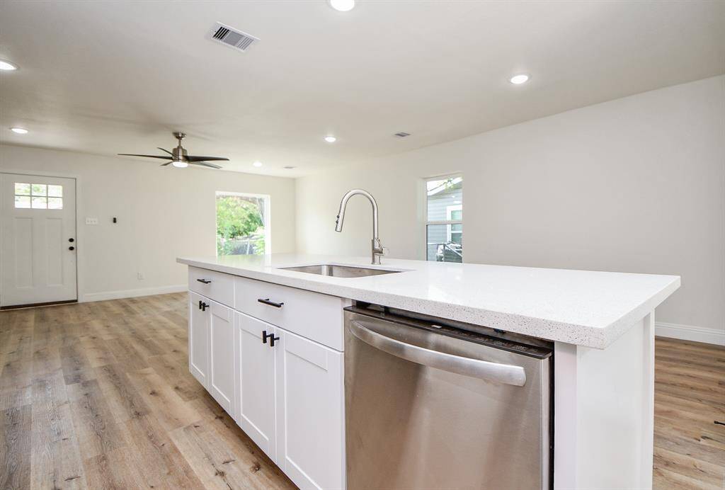 Island with quartz counters easily seats 4.