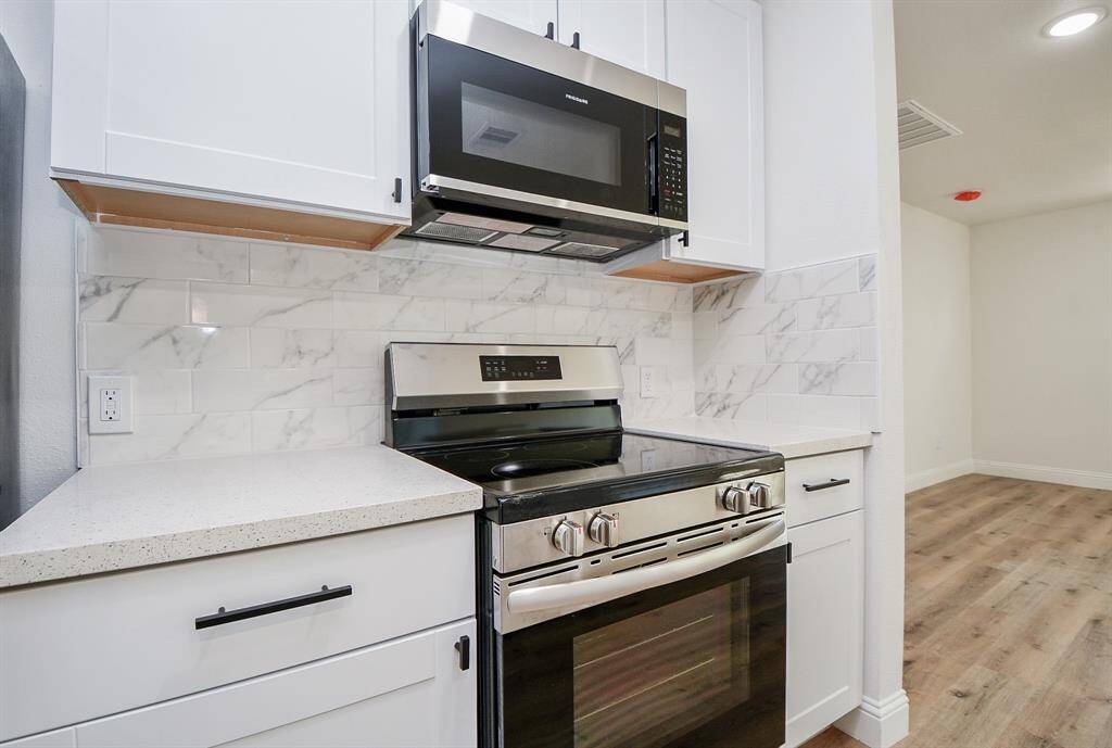 Quartz counters and stainless steel appliances.