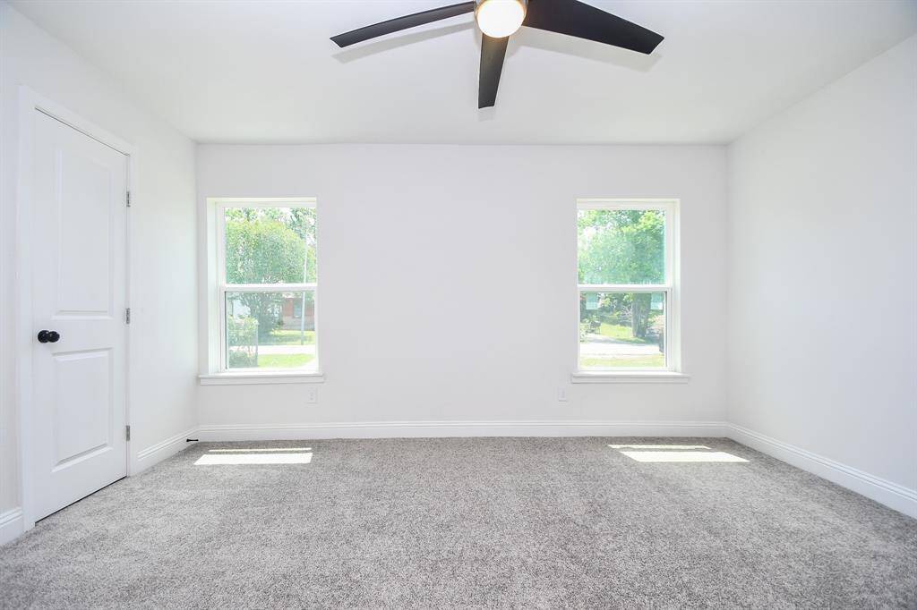 The primary bedroom has natural sunlight and faces the front of the home.