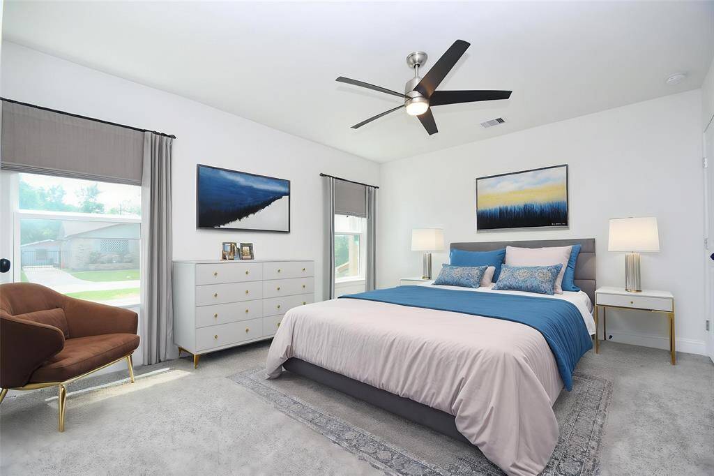 Virtually staged Primary Bedroom with views to the front yard.