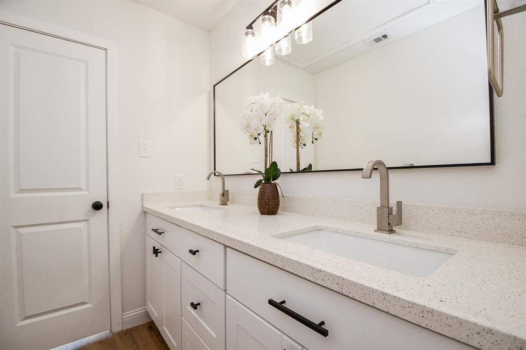 Secondary bathroom - double sinks and large mirror.