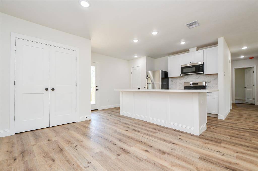 Behind those double doors is space for your stackable washer/dryer.