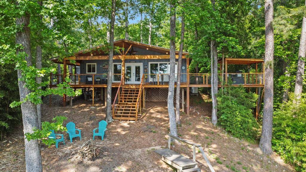 Fantastic view of covered porch, sitting area and firepit area