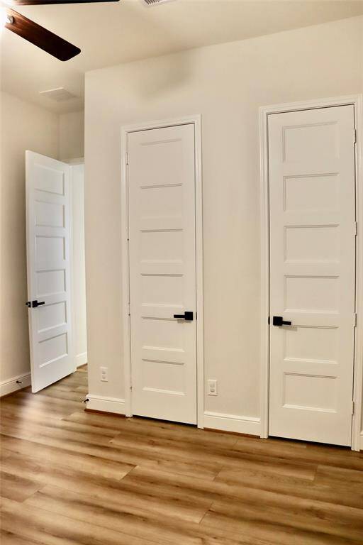 The fifth bedroom on the left side of the house has double closet doors