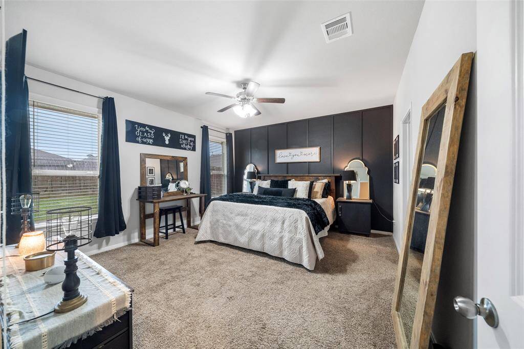 The Primary Bedroom is tucked away for privacy.  Note the custom accent wall.
