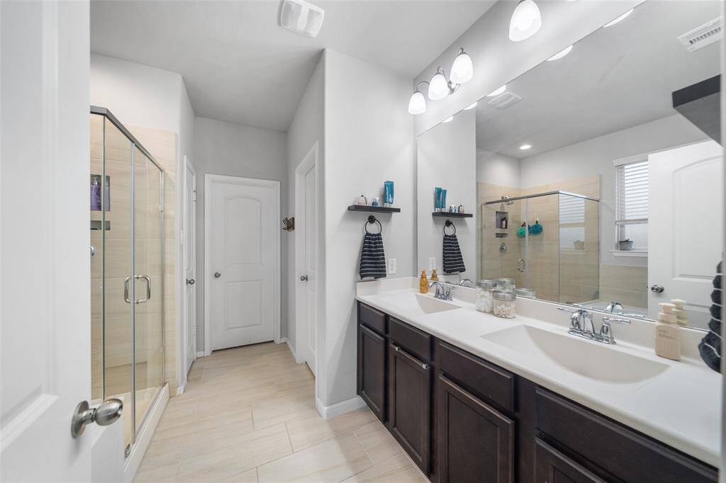 HIS/ HER sinks here in the Primary Bath, separate shower and bath.The bathtub is to the left