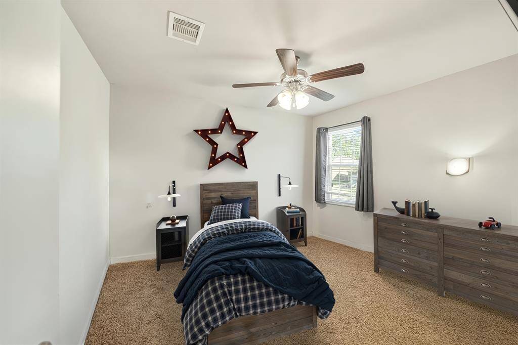 One os the large secondary bedrooms upstairs.  Digitally stages