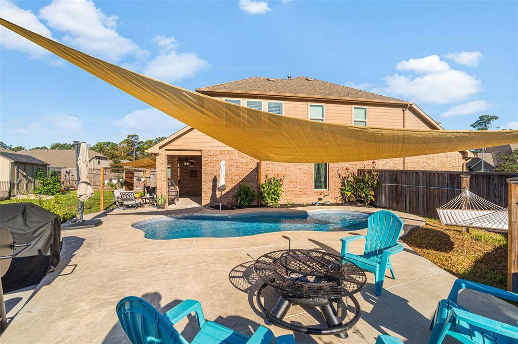 Can you see yourself enjoying the sparkling pool, cozy fire pit area and various areas to cook out?