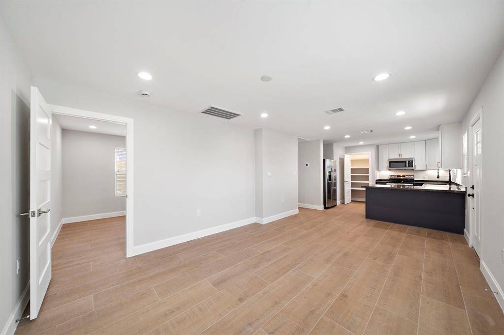 The bedroom door on left leads to the living room.