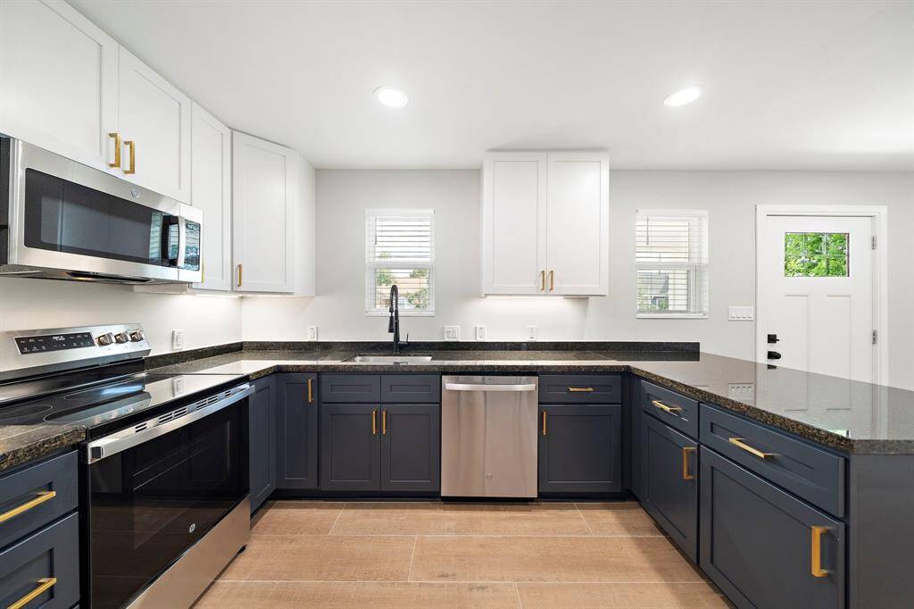 New cabinets and appliances that have never been used. Granite counters and a window above the sink.