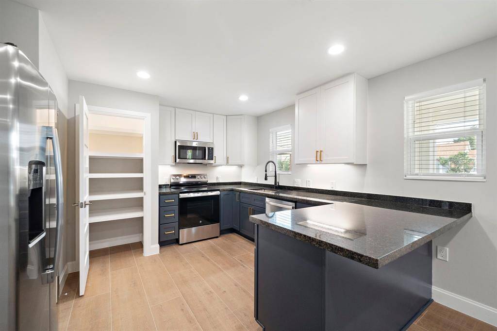 Bar seating on the kitchen peninsula and a nice pantry space.