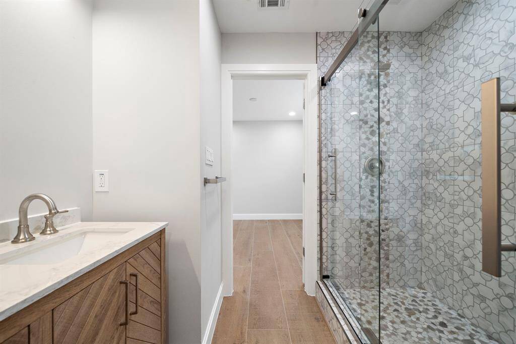 Huge walk in shower and double sinks. The bathroom is between the two bedrooms.