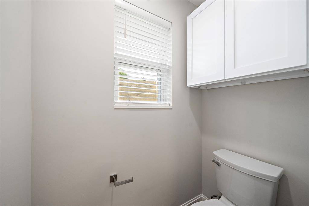 Extra storage above the toilet and a window for natural light.