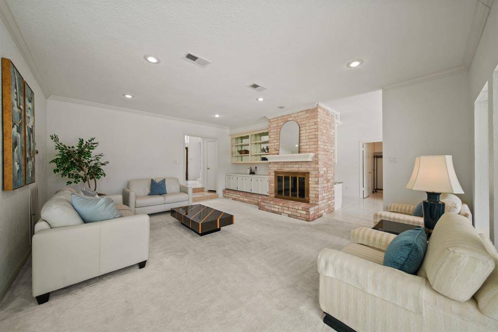 The brick fireplace and built-ins are nice touches in the family room.