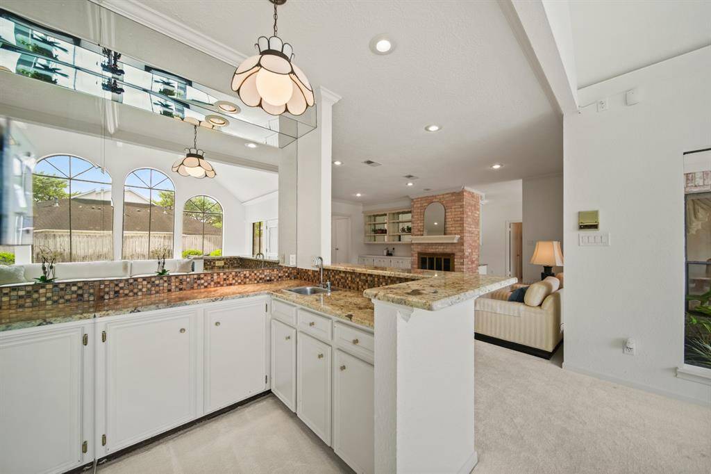 This home was designed with entertaining in mind. The wet bar is situated between the two living areas. Not showing in the picture, is a powder room that is located adjacent to the bar area.