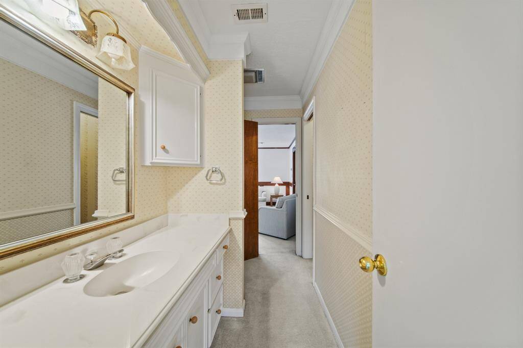 This bathroom is situated between a bedroom and the game room.
