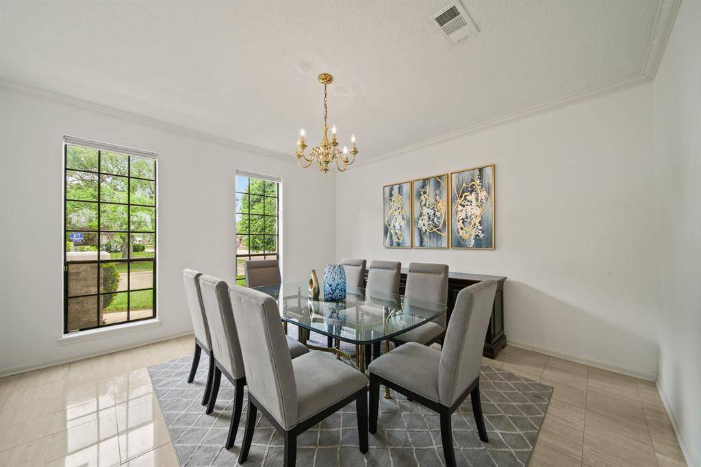The formal dining room has marble floors and a crown molding.