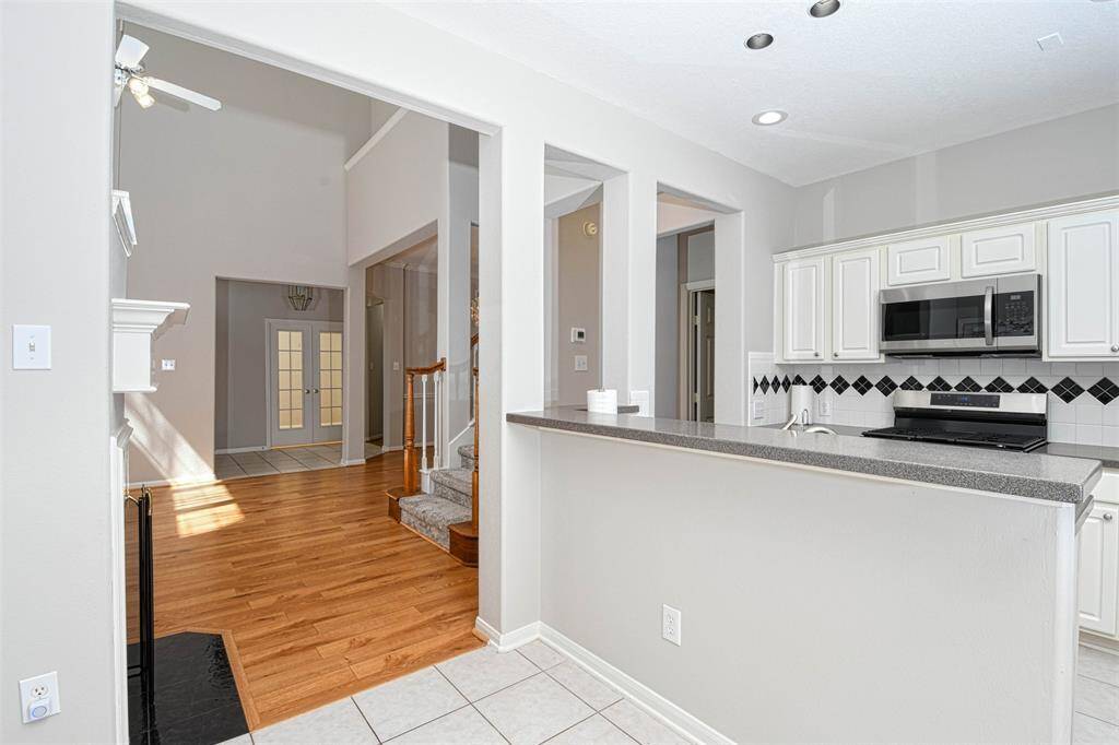 Quaint breakfast area with a breakfast bar. with lot of line and a view of the back patio.