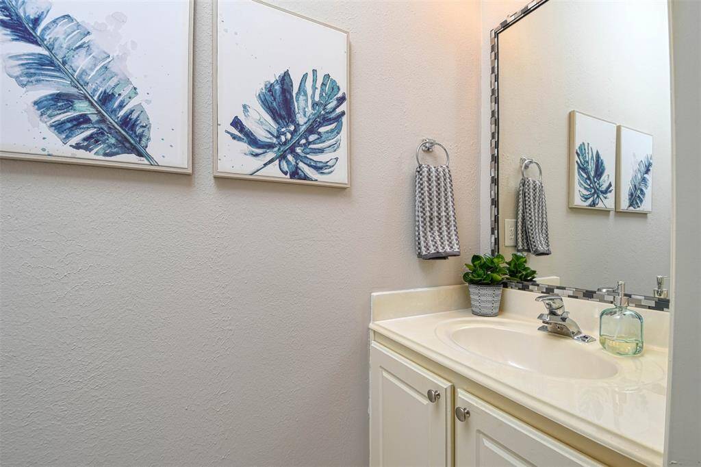 Half bath downstairs with a beautiful accented mirror.