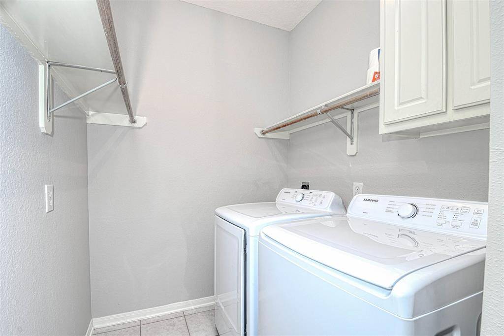 Brand new washer and dryer in the laundry room that has lots of storage and area to line dry your delicates