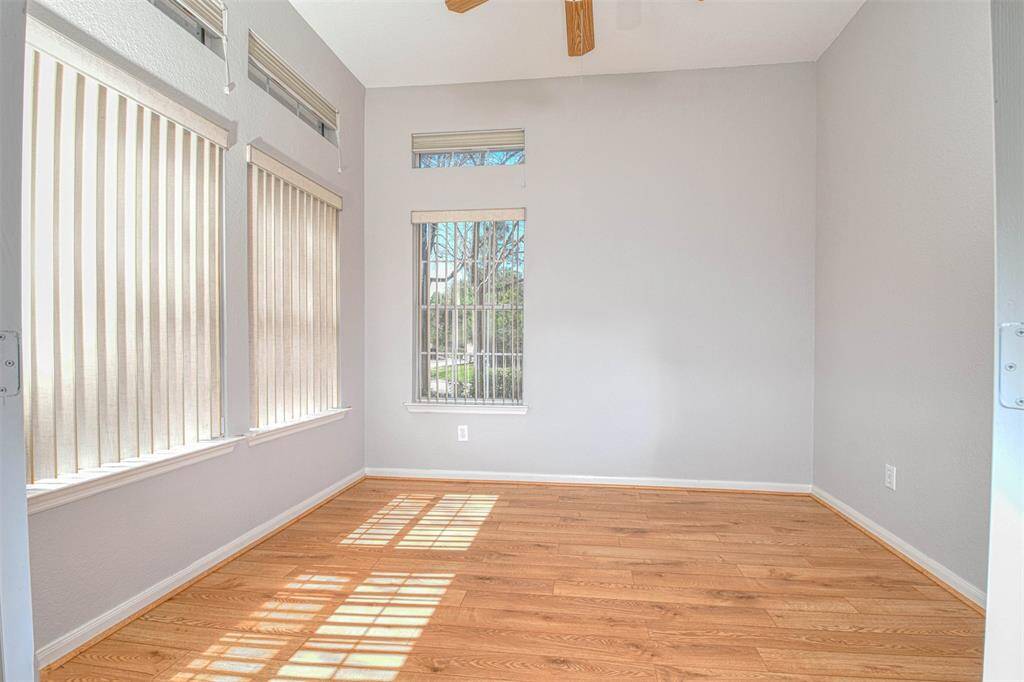 Living room has lots of windows, high ceilings