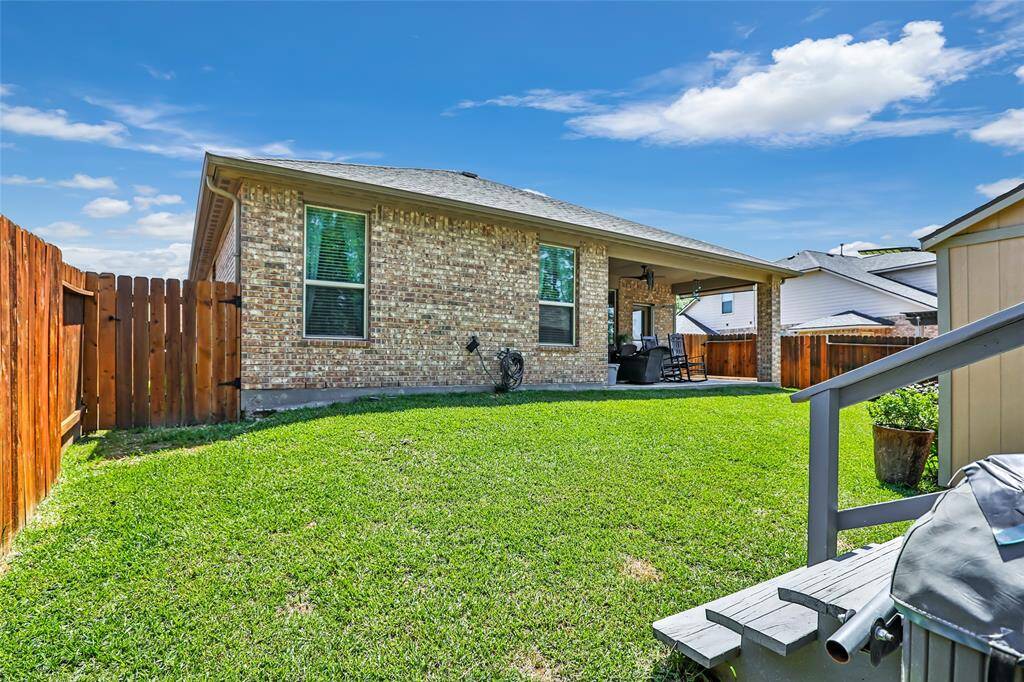 Enjoy the covered patio overlooking a private, fenced yard perfect for relaxation or entertaining.