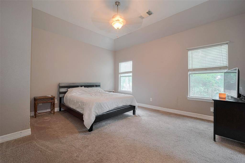 Primary bed with high ceilings