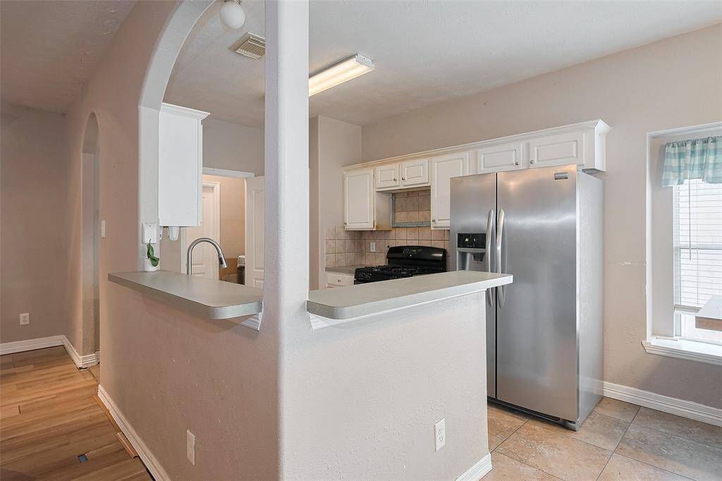This kitchen gets lots of natural sunlight and opens up to living!