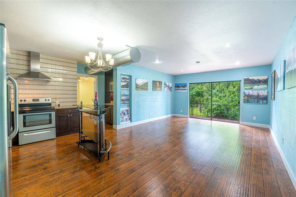 Spacious, high ceilings kitchen and living area with a beautiful view out to the balcony.