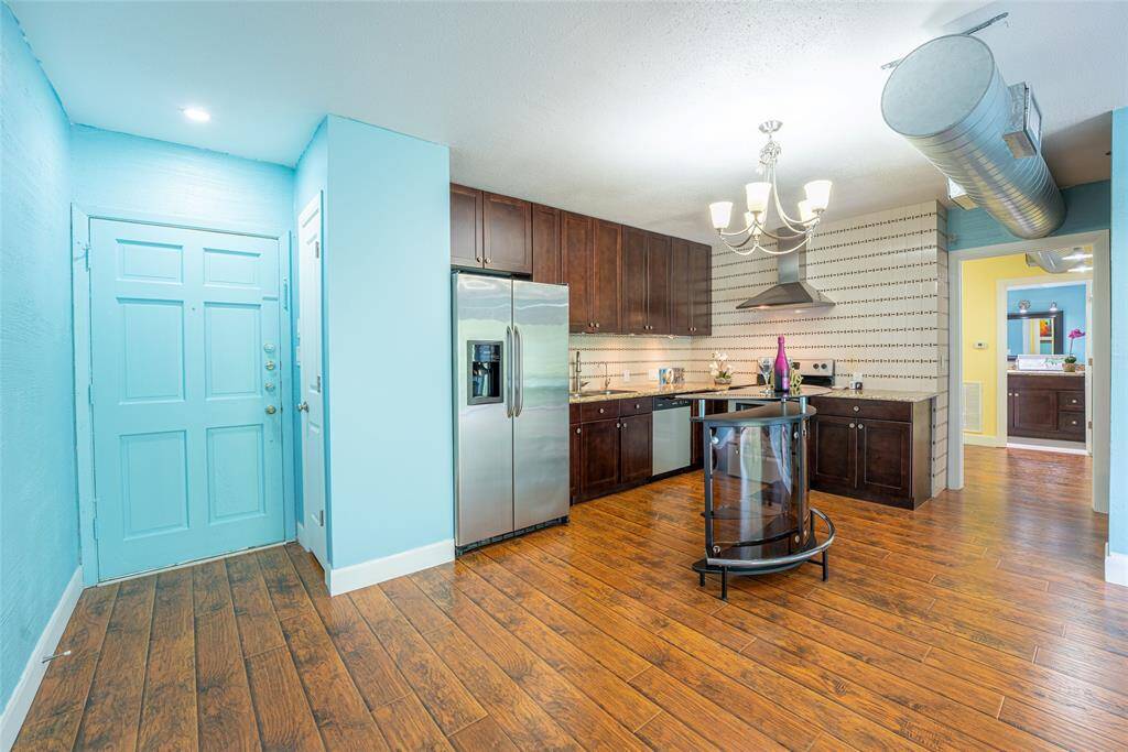 Front door entrance open into living dining area with a coat closet on the left