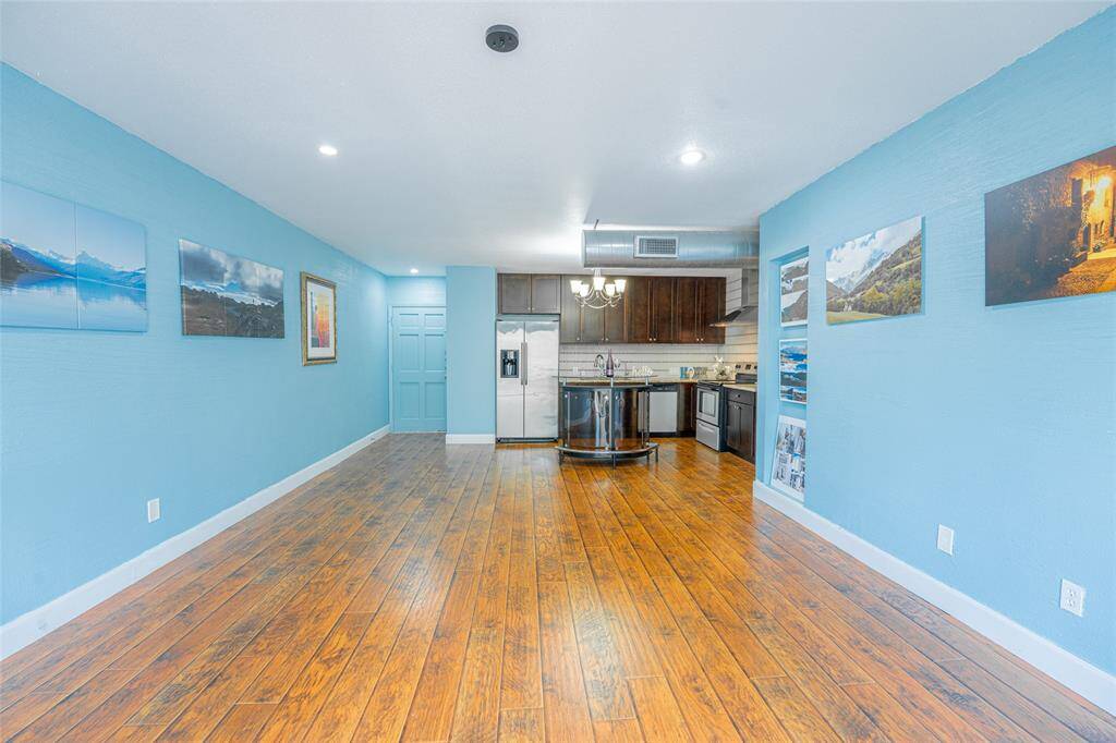View of open floor plan of living room, dining and kitchen from the balcony.