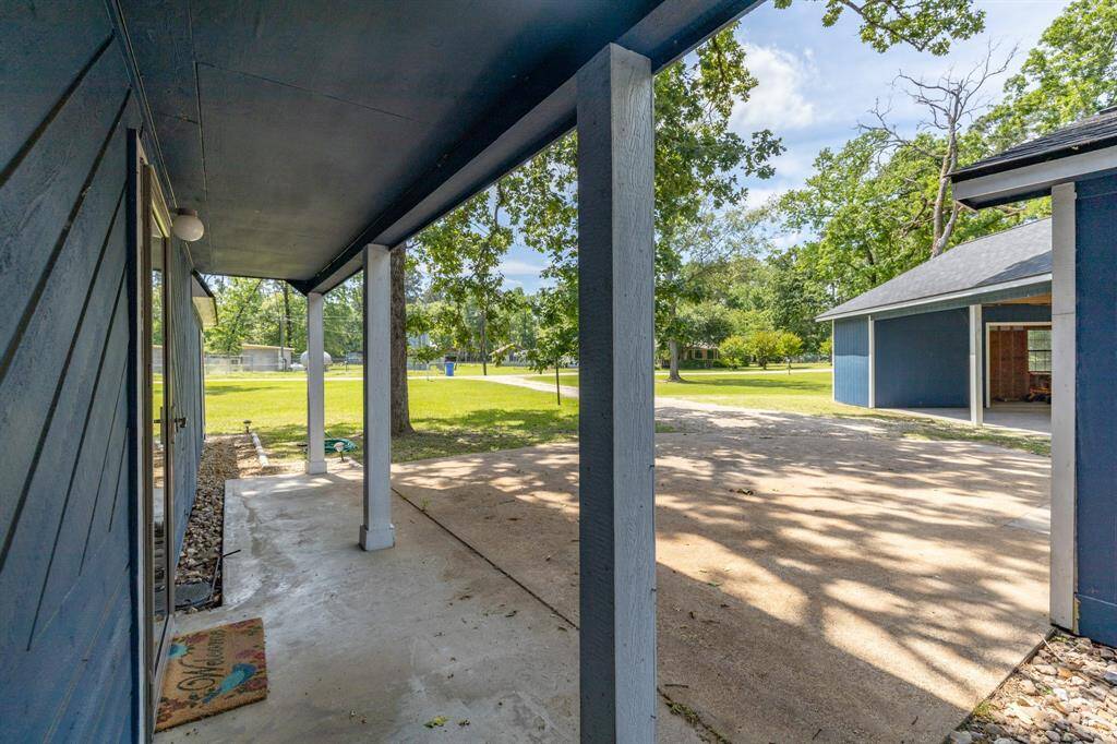 The large, covered front porch sets the tone with warmth and charm—perfect for greeting guests or enjoying the view