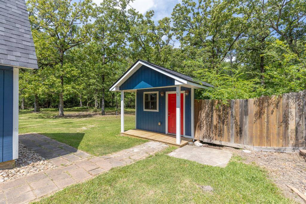 Adorable storage shed with a quaint front porch—perfect for stashing your mower, gardening tools, and pool supplies, all while adding a touch of charm to your backyard!