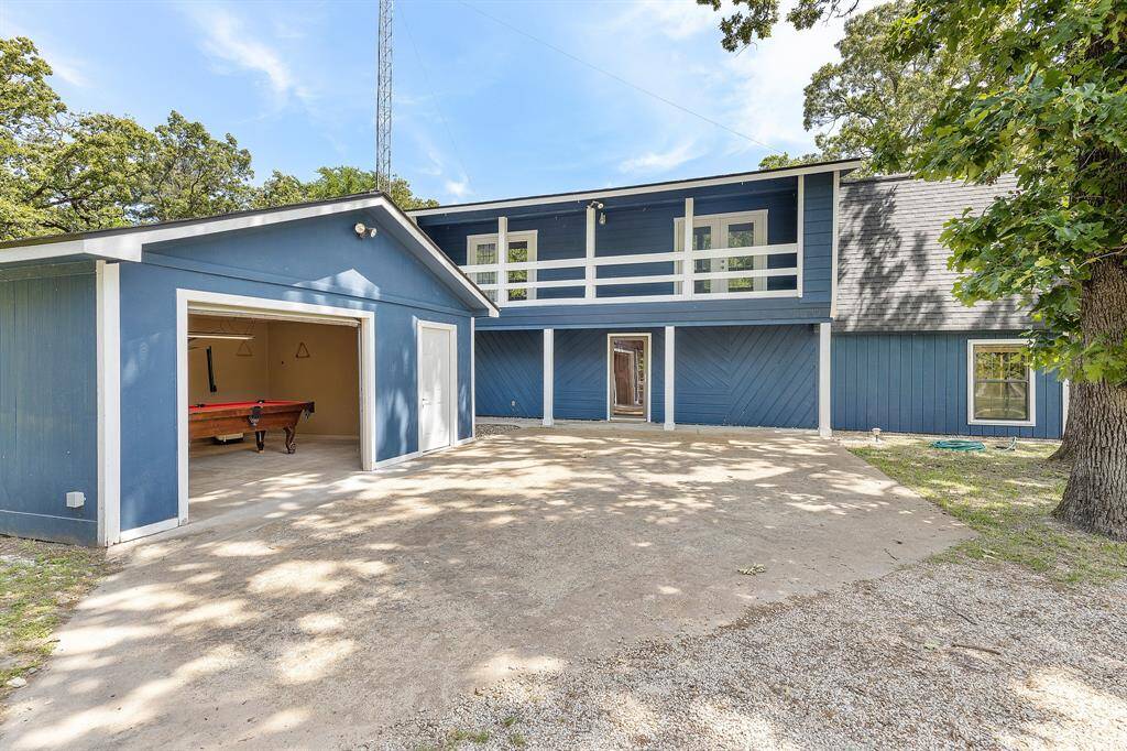View of the garage and house from the covered parking area