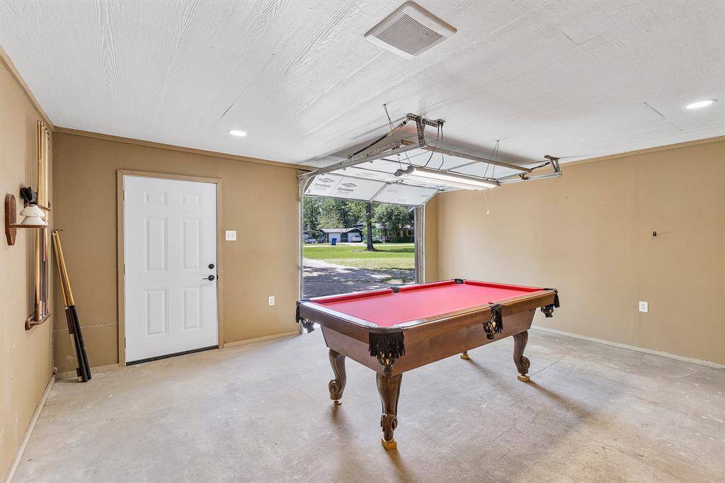 This garage isn’t just for cars—recessed lighting makes it the perfect spot for a pool table, hangout zone, or your next big project.