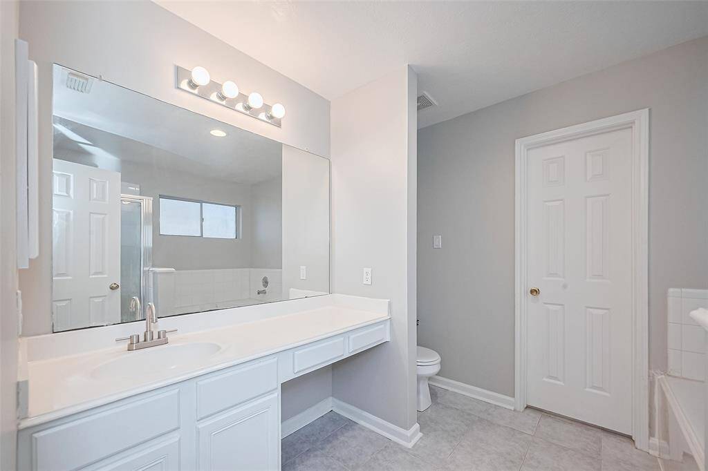Primary Bathroom; Features a relaxing jacuzzi tub and separate shower your personal retreat.