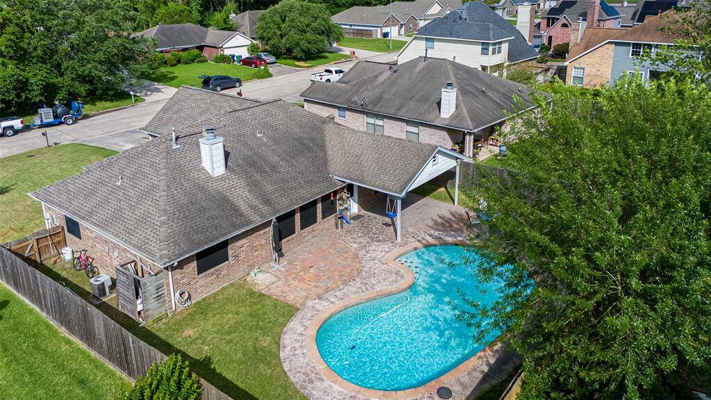 Enjoy a well-sized fenced backyard featuring a refreshing pool—perfect for Texas summers—plus a covered patio for shaded outdoor relaxation.