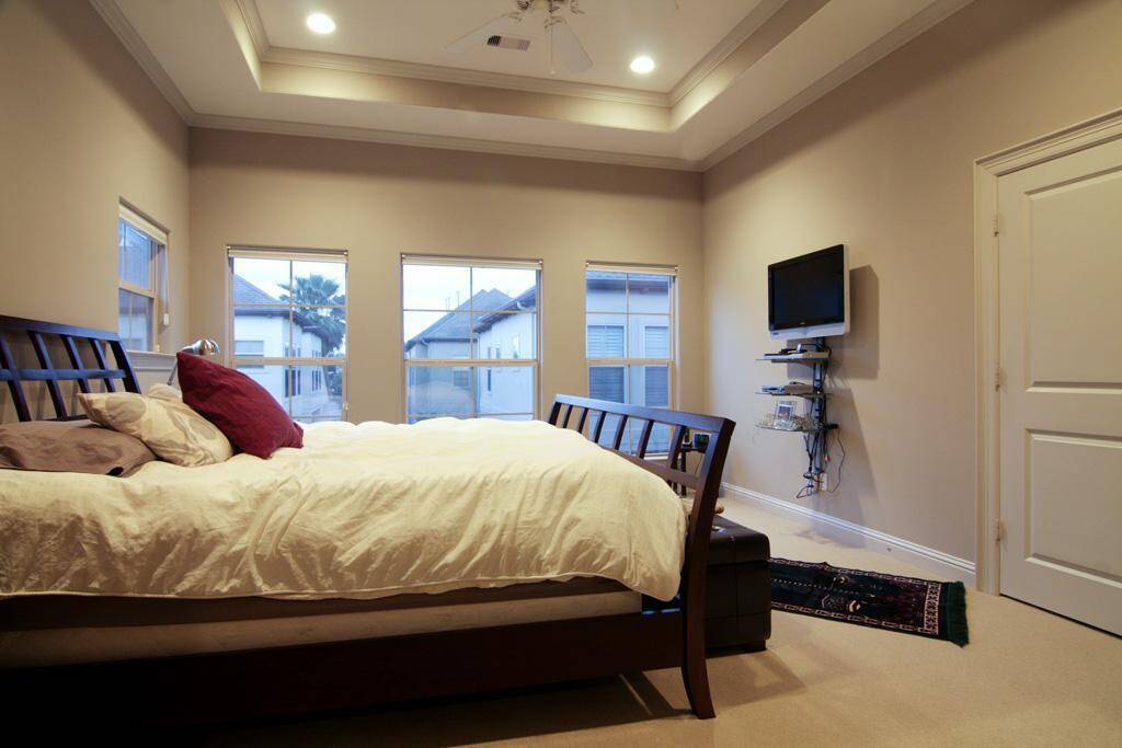 Oversized primary bedroom with coffered ceiling, fully adjustable blinds throughout house