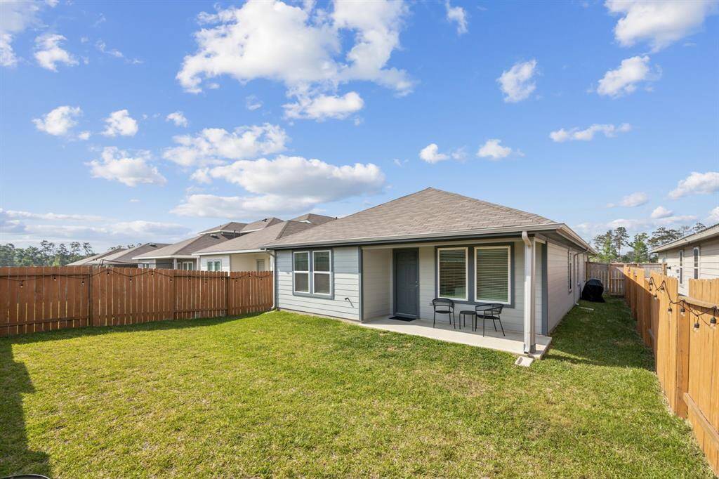 Backyard features spacious covered patio.