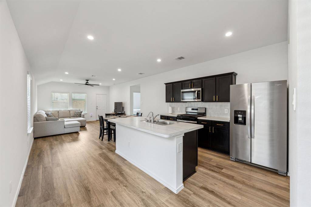 Kitchen features all stainless steel appliances and has lots of room to add barstools for additional seating. Fridge is Included.