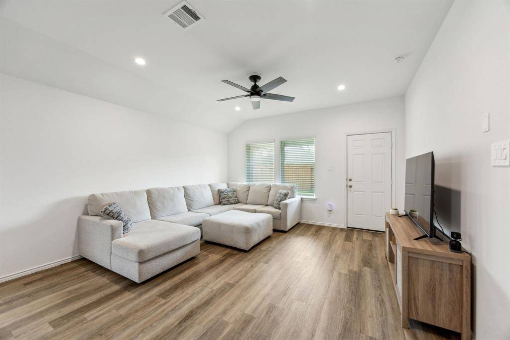 Large living area with ceiling fan for added comfort.